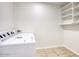 A functional laundry room with washer and dryer hookups and built-in shelving at 3841 N 21St Ave, Phoenix, AZ 85015