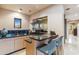 Entertainer's bar with granite countertops, comfortable seating, and scenic desert views at 39602 N Charles Blair Macdonald Rd, Scottsdale, AZ 85262