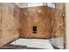 Enclosed bathtub-shower featuring designer stone tiling, a built-in soap nook, and sleek glass partitions at 39602 N Charles Blair Macdonald Rd, Scottsdale, AZ 85262