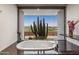 Luxurious soaking tub with desert views, marble counters, and elegant fixtures create a spa-like bathroom retreat at 39602 N Charles Blair Macdonald Rd, Scottsdale, AZ 85262