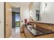 Modern bathroom features a stone vanity, granite countertop, and access to an outdoor patio at 39602 N Charles Blair Macdonald Rd, Scottsdale, AZ 85262