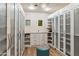 Spacious walk-in closet with custom shelving, stylish chandelier, and ample storage, a fashion lover's dream at 39602 N Charles Blair Macdonald Rd, Scottsdale, AZ 85262