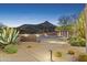 Driveway with desert landscaping and modern exterior lighting at 39602 N Charles Blair Macdonald Rd, Scottsdale, AZ 85262