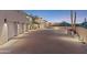 Paved driveway leading to a three-car garage, with desert landscaping and modern exterior lighting at 39602 N Charles Blair Macdonald Rd, Scottsdale, AZ 85262