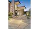 Stunning home featuring a stone accent wall, desert landscaping, and a grand entrance with ample lighting at 39602 N Charles Blair Macdonald Rd, Scottsdale, AZ 85262