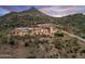 Stunning desert home with mountain backdrop, featuring an open design, outdoor fireplace, and desert landscaping at 39602 N Charles Blair Macdonald Rd, Scottsdale, AZ 85262