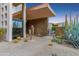 Stunning modern home showcasing desert landscaping, stone accents, and unique architectural design at 39602 N Charles Blair Macdonald Rd, Scottsdale, AZ 85262