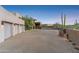 Three-car garage with a circular driveway, and desert landscaping at 39602 N Charles Blair Macdonald Rd, Scottsdale, AZ 85262