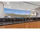 Modern kitchen with scenic outdoor views, granite countertops, and stainless steel appliances at 39602 N Charles Blair Macdonald Rd, Scottsdale, AZ 85262