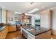 Contemporary kitchen with stone accents, granite countertops, and stainless steel appliances at 39602 N Charles Blair Macdonald Rd, Scottsdale, AZ 85262