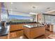 Open concept kitchen with large windows, granite countertops, and modern stainless steel appliances at 39602 N Charles Blair Macdonald Rd, Scottsdale, AZ 85262