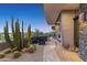 Modern patio with desert landscaping, gravel accents, a desert view, and an outdoor fireplace at 39602 N Charles Blair Macdonald Rd, Scottsdale, AZ 85262