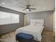 Comfortable bedroom with wood-look tile flooring, ceiling fan and a window at 4162 W Sierra St, Phoenix, AZ 85029