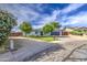 Charming single-story home featuring manicured landscaping, solar panels, and a spacious driveway at 4162 W Sierra St, Phoenix, AZ 85029