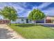 Charming single-story home featuring manicured landscaping, solar panels, and a spacious driveway at 4162 W Sierra St, Phoenix, AZ 85029