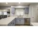 Kitchen showcases bright countertops, a stainless dishwasher, and modern light gray cabinetry at 4162 W Sierra St, Phoenix, AZ 85029