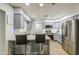 Updated kitchen with stainless appliances, quartz countertops, breakfast bar and light gray cabinets at 4162 W Sierra St, Phoenix, AZ 85029