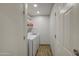 Efficient laundry room with modern washer and dryer, complemented by storage shelves and clean white finishes at 4162 W Sierra St, Phoenix, AZ 85029