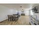 Open-concept living area with wood-look tile floors, dining set, and entertainment area at 4162 W Sierra St, Phoenix, AZ 85029