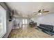 Open living space featuring wood-look floors, ceiling fan, and an abundance of natural light at 4162 W Sierra St, Phoenix, AZ 85029