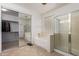 Primary bathroom featuring soaking tub, glass shower, and mirrored closet doors at 43228 W Knauss Dr, Maricopa, AZ 85138
