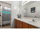 Bathroom featuring double vanity, large mirror, and shower/tub combination at 43228 W Knauss Dr, Maricopa, AZ 85138