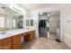 Well lit primary bath featuring double sinks, and access to walk-in closet at 43228 W Knauss Dr, Maricopa, AZ 85138