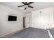 Bedroom featuring large closet, ceiling fan, and mounted TV at 43228 W Knauss Dr, Maricopa, AZ 85138