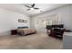 Bright bedroom with large windows, a ceiling fan, and a built-in workstation at 43228 W Knauss Dr, Maricopa, AZ 85138
