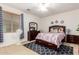 Bedroom with wood furniture, ceiling fan and patterned comforter at 43228 W Knauss Dr, Maricopa, AZ 85138