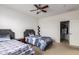 Bright bedroom featuring two twin beds, ceiling fan, and closet at 43228 W Knauss Dr, Maricopa, AZ 85138
