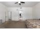 Spacious bedroom boasts plush carpet, ensuite bathroom, and a walk-in closet for ample storage at 43228 W Knauss Dr, Maricopa, AZ 85138