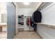 Organized walk-in closet with shelves and hanging rods, plus full length mirror at 43228 W Knauss Dr, Maricopa, AZ 85138