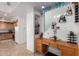 Stylish entryway features built in desk and shelving, complimented with elegant accents and decor and leading to kitchen at 43228 W Knauss Dr, Maricopa, AZ 85138