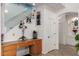 Inviting entryway with built-in desk space, wine rack, decorative plants, and staircase leading to upper level at 43228 W Knauss Dr, Maricopa, AZ 85138