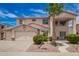 Charming two-story home boasts a well-manicured front yard, two-car garage, and a welcoming front porch at 43228 W Knauss Dr, Maricopa, AZ 85138