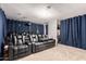 This in-home theater has multiple rows of reclining seats and a large projection screen at 43228 W Knauss Dr, Maricopa, AZ 85138