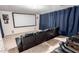 Home theater with tiered seating and a large projection screen is perfect for movie nights at 43228 W Knauss Dr, Maricopa, AZ 85138