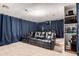 Comfortable home theater features tiered seating, a projector, and a large screen for immersive entertainment at 43228 W Knauss Dr, Maricopa, AZ 85138
