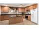 Spacious kitchen with a center island, stainless steel appliances, and ample cabinet space at 43228 W Knauss Dr, Maricopa, AZ 85138
