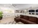 Upstairs living area with a brown sectional sofa and an open floor plan is brightly lit at 43228 W Knauss Dr, Maricopa, AZ 85138