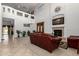 Spacious living room with high ceilings, fireplace, and plenty of natural light creates an open, airy feel at 43228 W Knauss Dr, Maricopa, AZ 85138