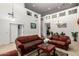 Open living room boasts high ceilings, neutral colors, and comfortable seating, creating a warm atmosphere at 43228 W Knauss Dr, Maricopa, AZ 85138