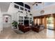 Spacious living room offers high ceilings, custom shelving, and ample space for entertaining and relaxing at 43228 W Knauss Dr, Maricopa, AZ 85138