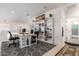 Bright loft area features a built-in bookshelf and a workstation with neutral paint and carpeted floors at 43228 W Knauss Dr, Maricopa, AZ 85138