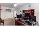 Office featuring a large desk, built-in shelving, and a ceiling fan at 43228 W Knauss Dr, Maricopa, AZ 85138