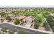Stunning aerial view of home featuring a pool, solar panels, a three car garage, and a tile roof at 5029 S Carlyle Dr, Gilbert, AZ 85298