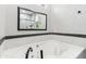 Relaxing bathroom showcasing a large soaking tub with black hardware accents at 5029 S Carlyle Dr, Gilbert, AZ 85298