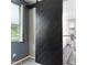 Bright bathroom featuring a black sliding barn door and a modern tiled bathtub at 5029 S Carlyle Dr, Gilbert, AZ 85298