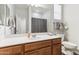 Clean bathroom featuring a white countertop, wooden vanity, and tiled toilet area at 5029 S Carlyle Dr, Gilbert, AZ 85298